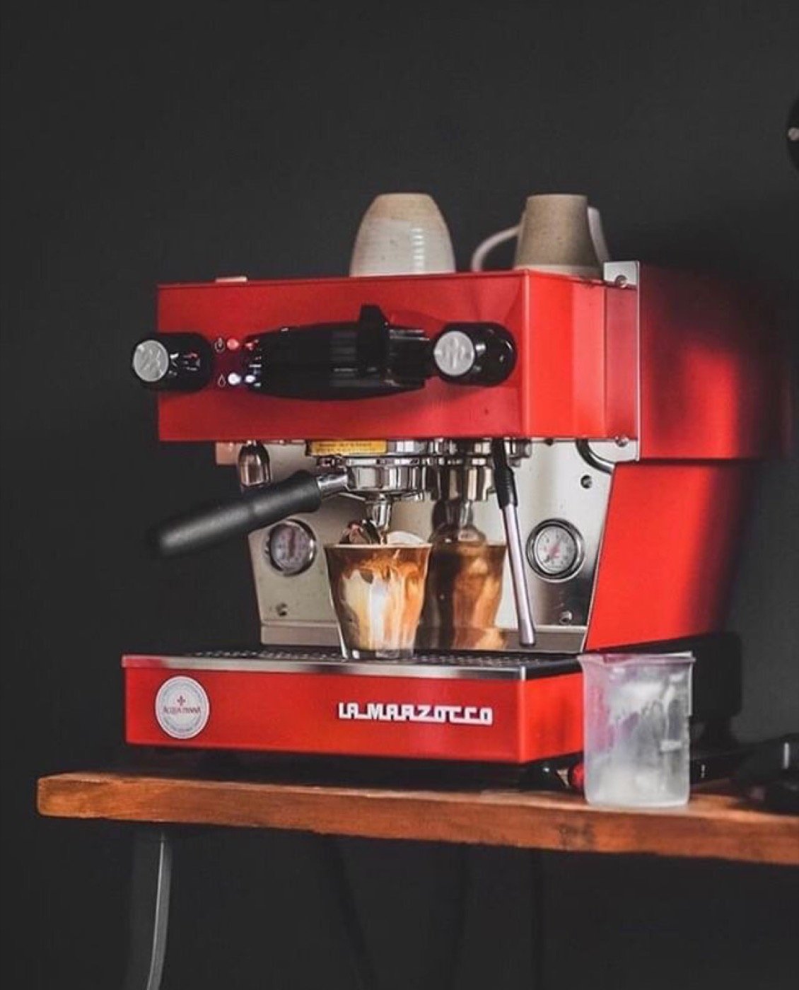 Red La Marzocco machine on a coffee bar