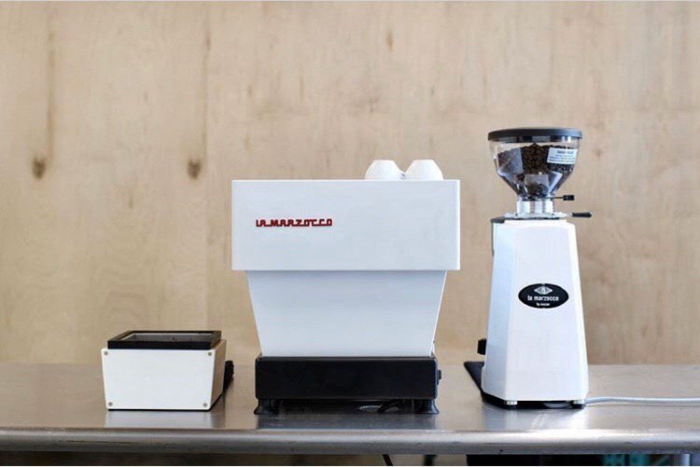 White espresso machine and grinder on a counter